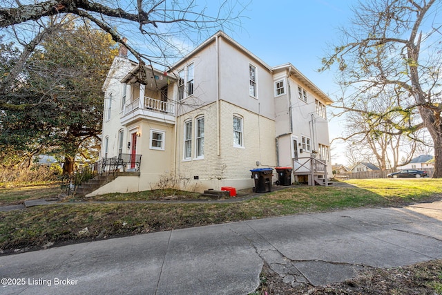 view of side of property with a balcony