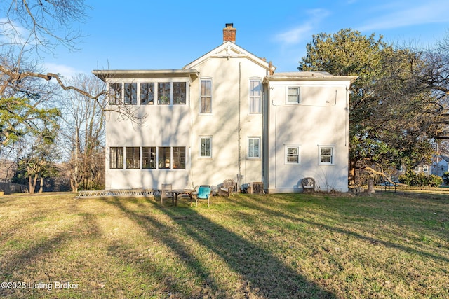 rear view of property featuring cooling unit and a yard