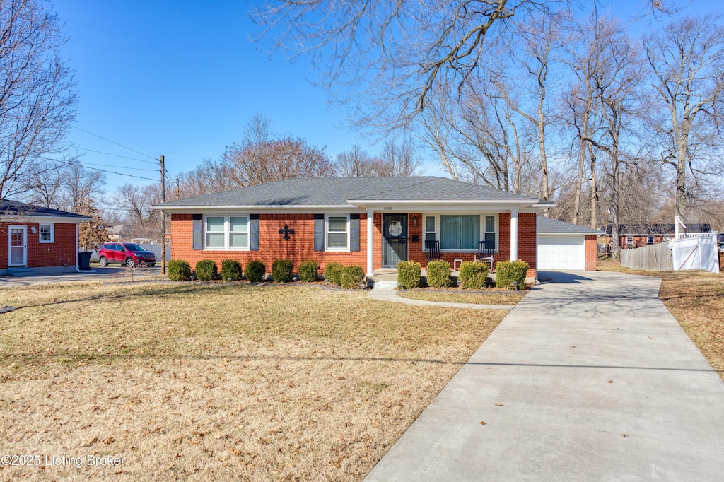 ranch-style house featuring a garage, covered porch, and a front lawn