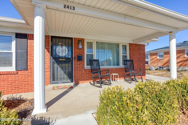 view of exterior entry featuring covered porch