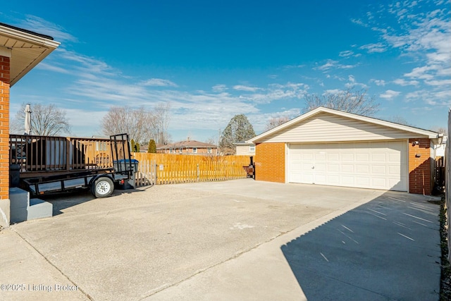 view of property exterior featuring a garage, brick siding, an outbuilding, and fence