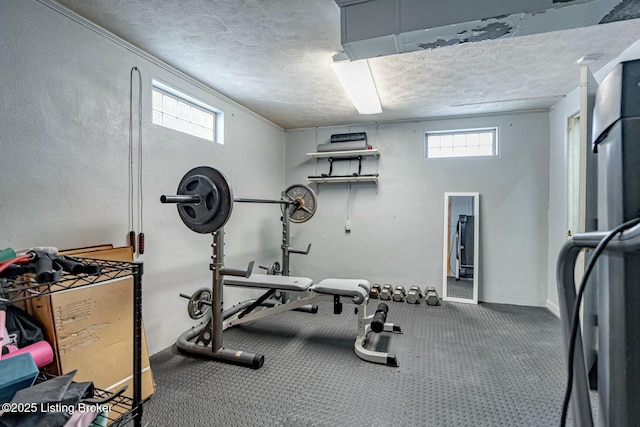 exercise area featuring baseboards and a textured ceiling