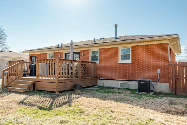 back of property featuring cooling unit, brick siding, fence, a yard, and a wooden deck