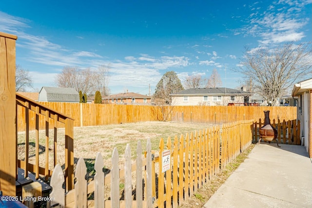 view of yard featuring a residential view and a fenced backyard