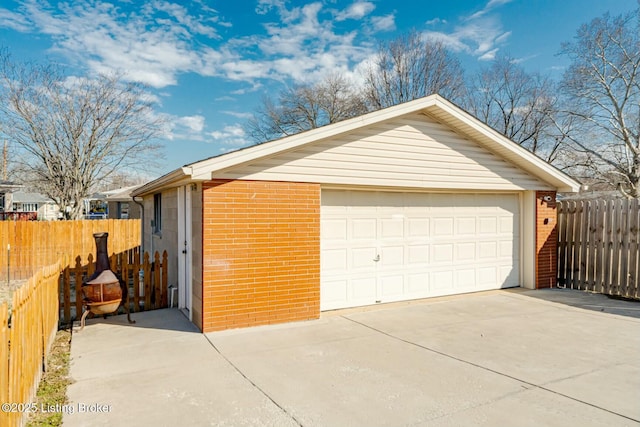 detached garage featuring fence