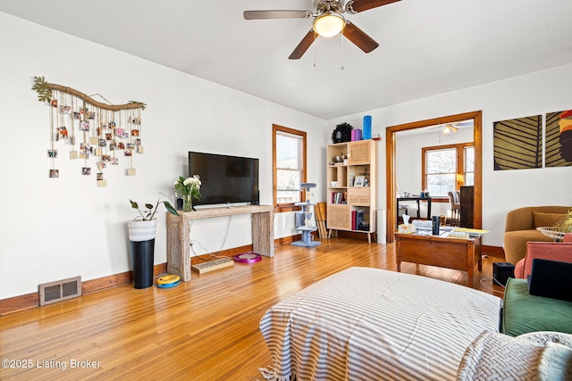 living room featuring ceiling fan and hardwood / wood-style floors