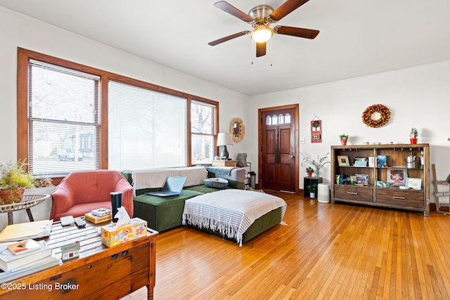 living room with wood-type flooring and ceiling fan