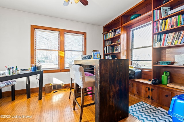 office space featuring ceiling fan and light hardwood / wood-style floors