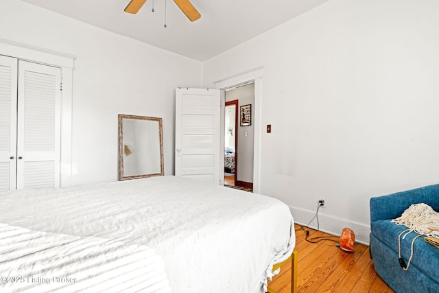 bedroom featuring hardwood / wood-style flooring, a closet, and ceiling fan