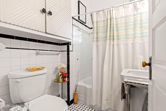 bathroom featuring shower / bath combination with curtain, toilet, and tile walls