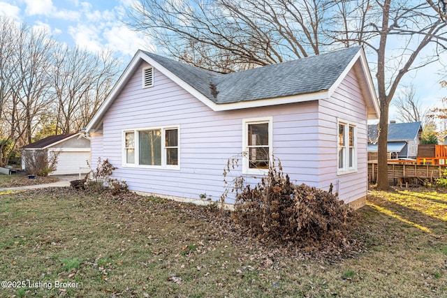 view of property exterior with a garage and a yard