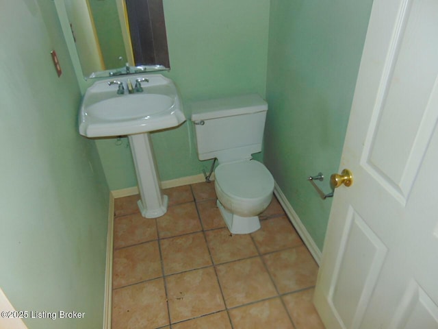 bathroom with tile patterned floors and toilet