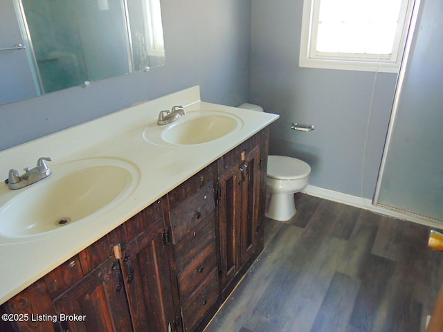 bathroom with hardwood / wood-style flooring, vanity, and toilet