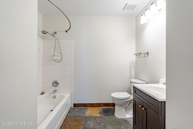 full bath with stone tile floors, visible vents, toilet, vanity, and baseboards