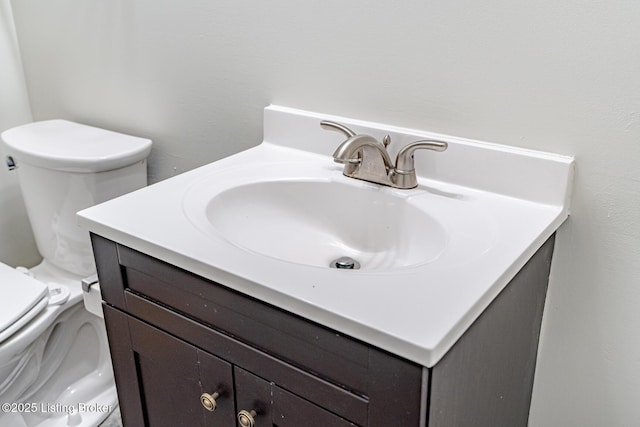 bathroom featuring toilet and vanity