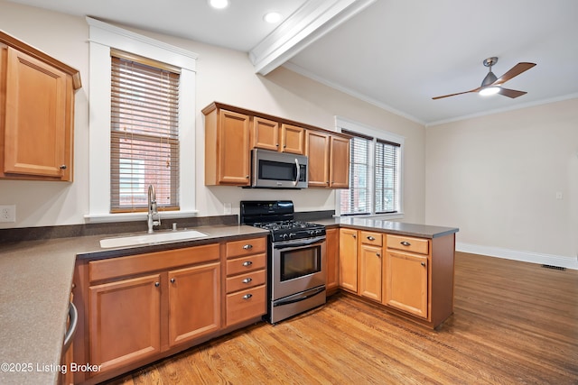 kitchen with sink, kitchen peninsula, stainless steel appliances, crown molding, and light wood-type flooring