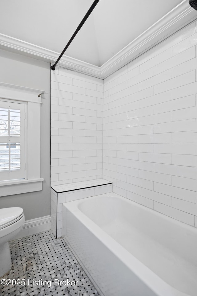 bathroom featuring tiled shower / bath, ornamental molding, toilet, and tile patterned floors