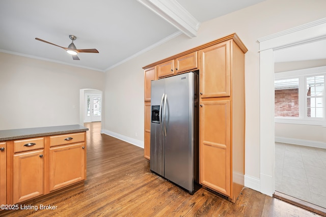 kitchen featuring ceiling fan, beam ceiling, dark hardwood / wood-style floors, stainless steel refrigerator with ice dispenser, and ornamental molding