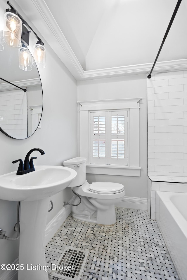 bathroom with vaulted ceiling, bathtub / shower combination, and toilet