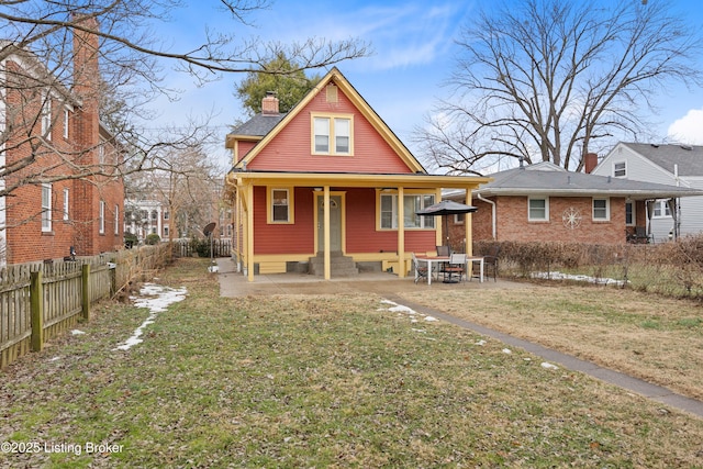 bungalow-style home with a patio and a front lawn