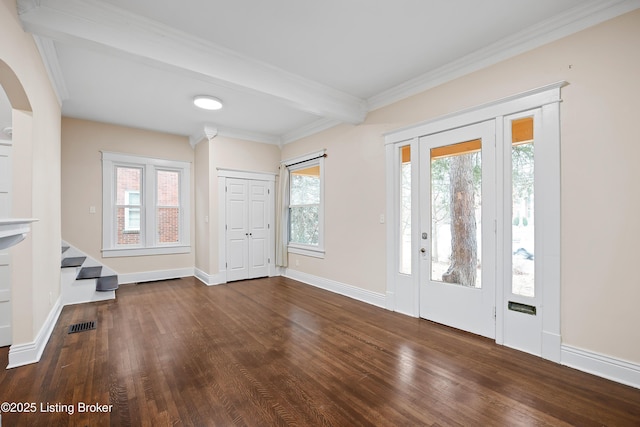 entryway featuring ornamental molding, dark hardwood / wood-style floors, beam ceiling, and a wealth of natural light