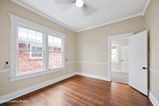 empty room featuring ceiling fan, ornamental molding, and dark hardwood / wood-style floors