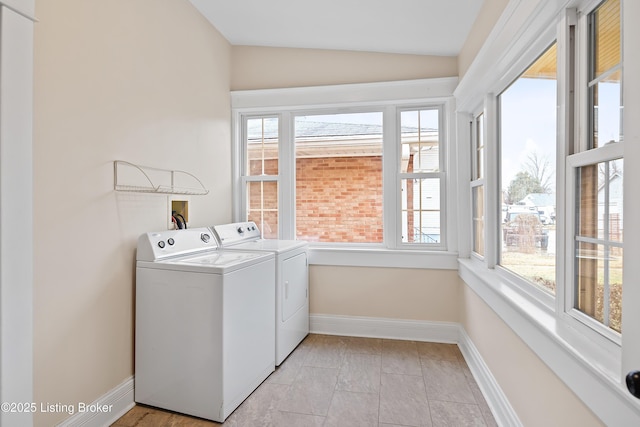 washroom with a healthy amount of sunlight and washer and dryer