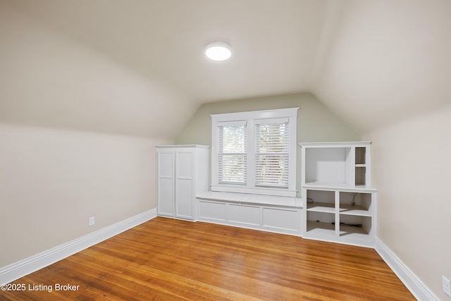 bonus room featuring light hardwood / wood-style flooring and vaulted ceiling