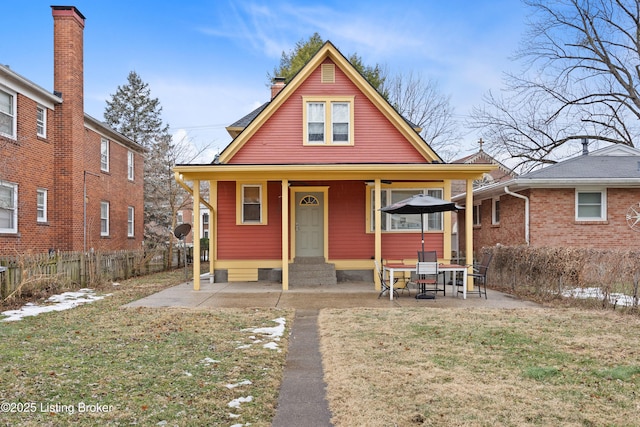 bungalow-style house featuring a patio area and a front yard