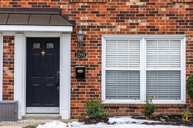 view of snow covered property entrance