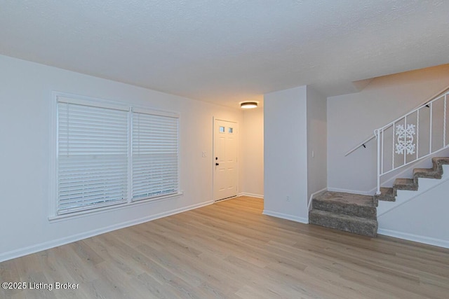 foyer featuring light hardwood / wood-style flooring and a textured ceiling