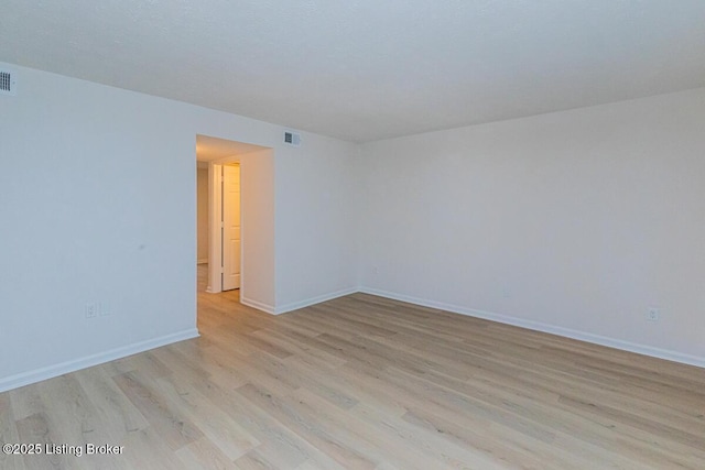 spare room featuring light wood-type flooring