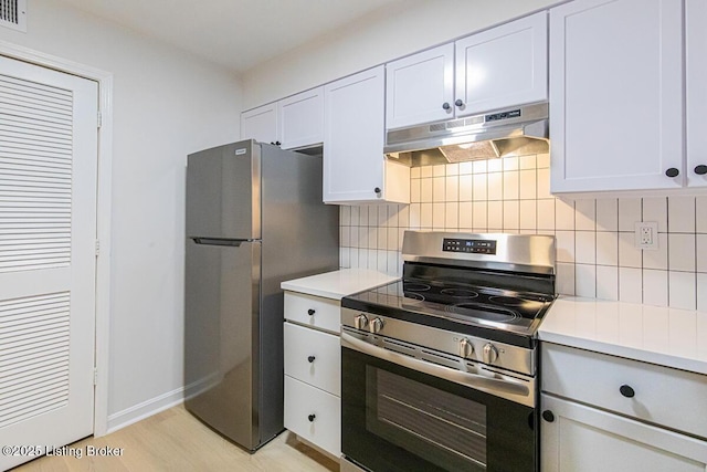 kitchen featuring white cabinetry, backsplash, light hardwood / wood-style flooring, and stainless steel appliances