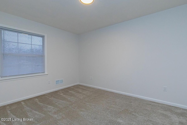 empty room featuring light carpet