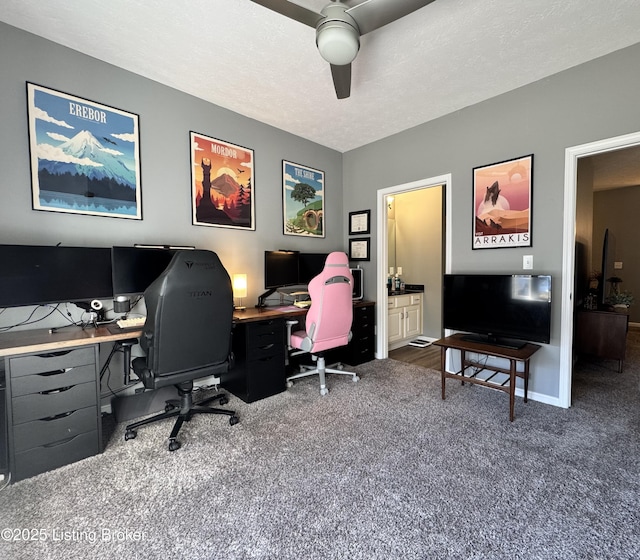 office area with dark colored carpet, a textured ceiling, and ceiling fan