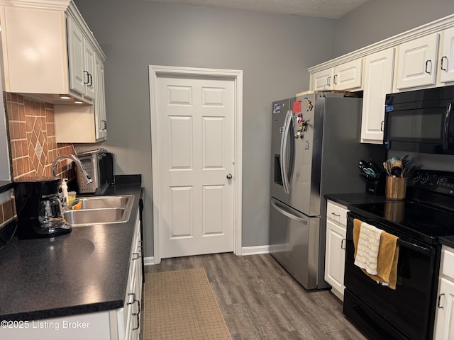 kitchen featuring sink, white cabinetry, dark hardwood / wood-style floors, tasteful backsplash, and black appliances