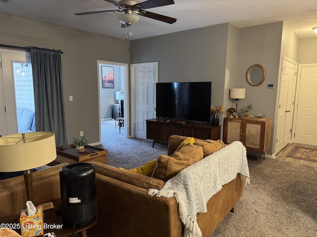 carpeted living room with ceiling fan