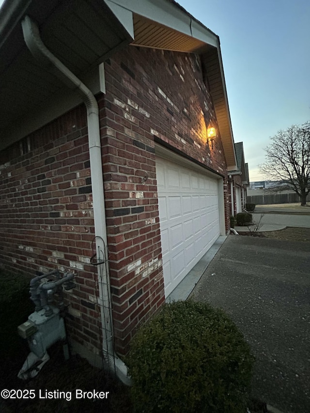 property exterior at dusk featuring a garage