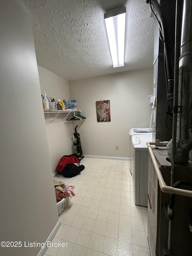 laundry room with a textured ceiling and independent washer and dryer