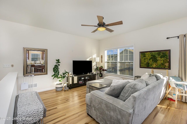 living room with ceiling fan and light wood-type flooring