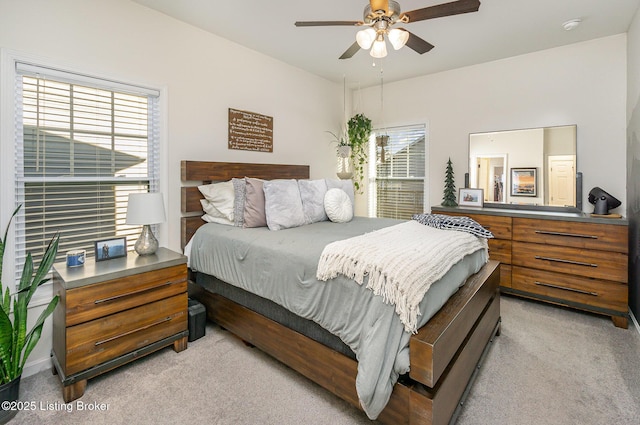 bedroom featuring light colored carpet and ceiling fan