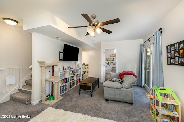 carpeted living room with ceiling fan