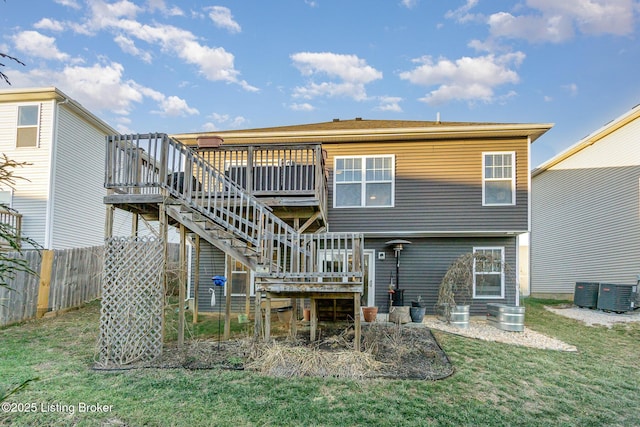 back of property featuring a wooden deck, a lawn, and central air condition unit