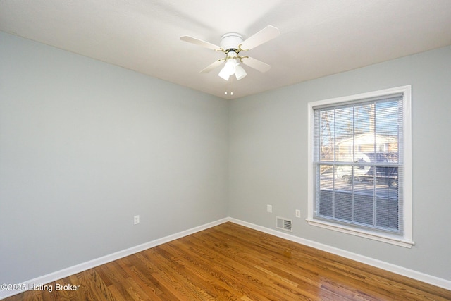 spare room featuring wood-type flooring and ceiling fan