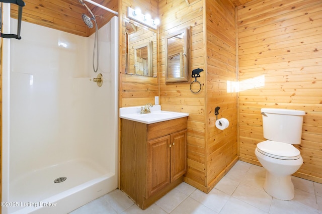 bathroom featuring walk in shower, tile patterned floors, toilet, wood walls, and vanity