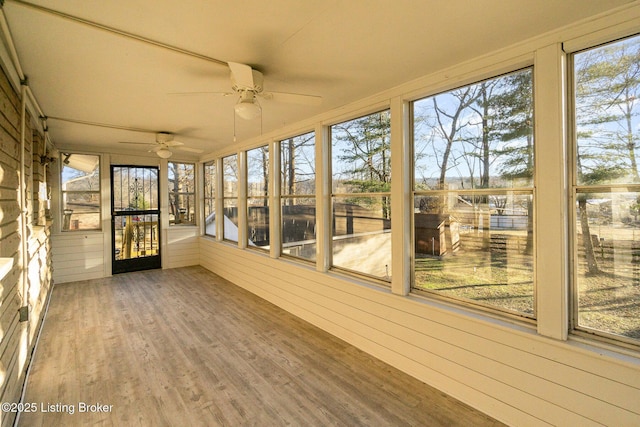 unfurnished sunroom featuring ceiling fan