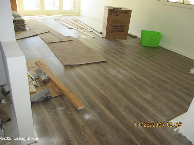 unfurnished living room with dark wood-type flooring