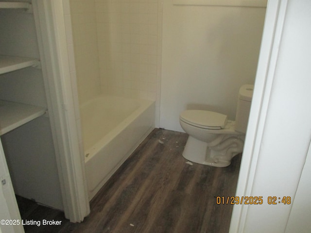 bathroom with hardwood / wood-style flooring and toilet