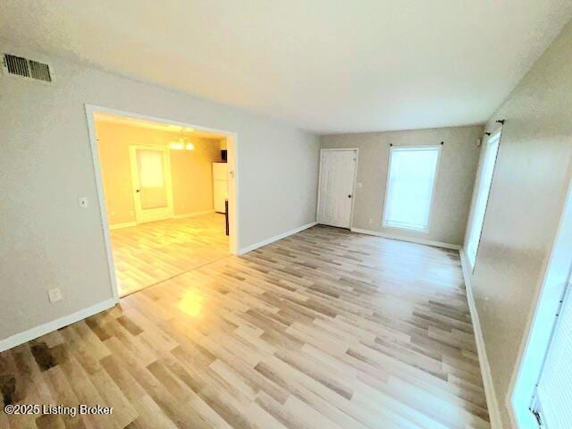 spare room featuring light wood-type flooring