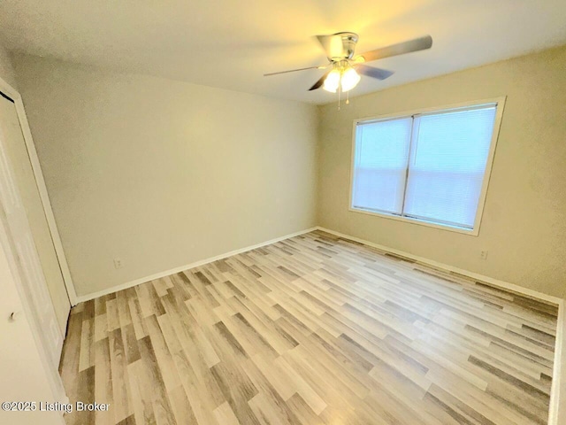 spare room featuring light hardwood / wood-style floors and ceiling fan